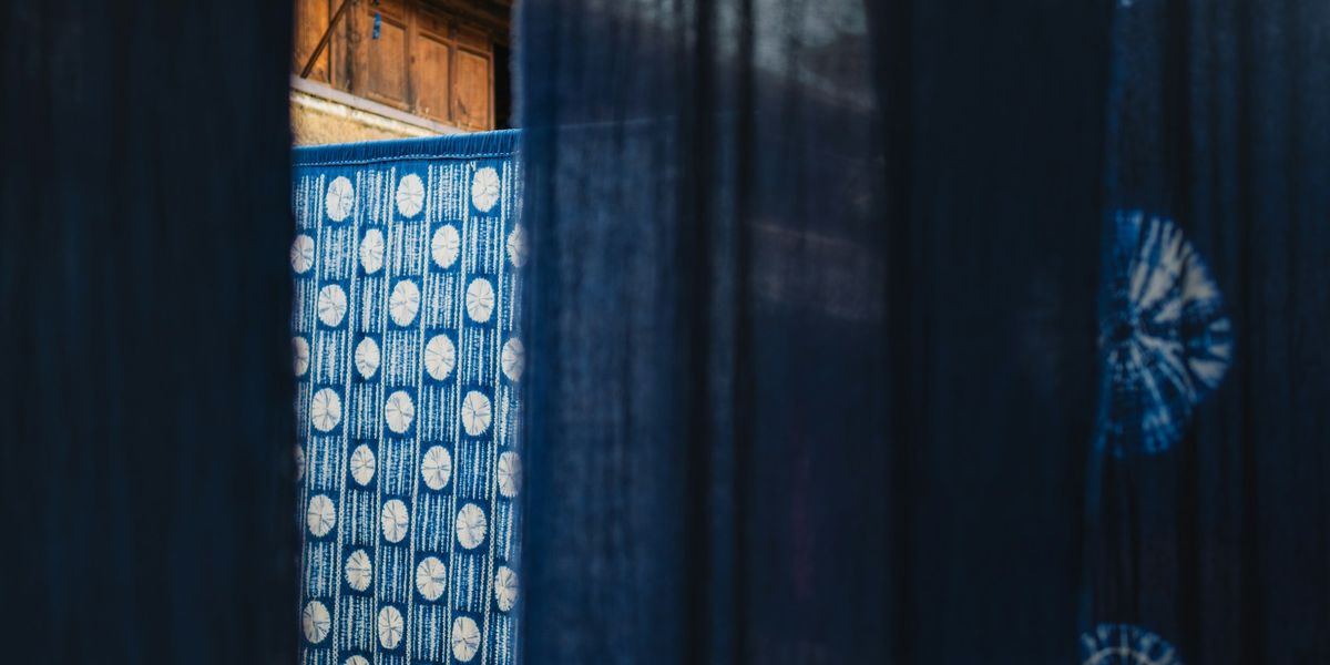 Indigo-dyed cloth hanging in a dark doorway