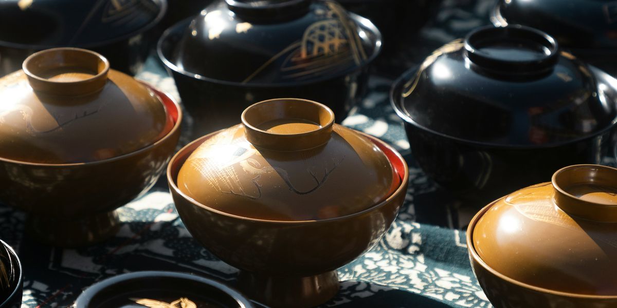 Lidded urushi lacquer bowls laid out on a table
