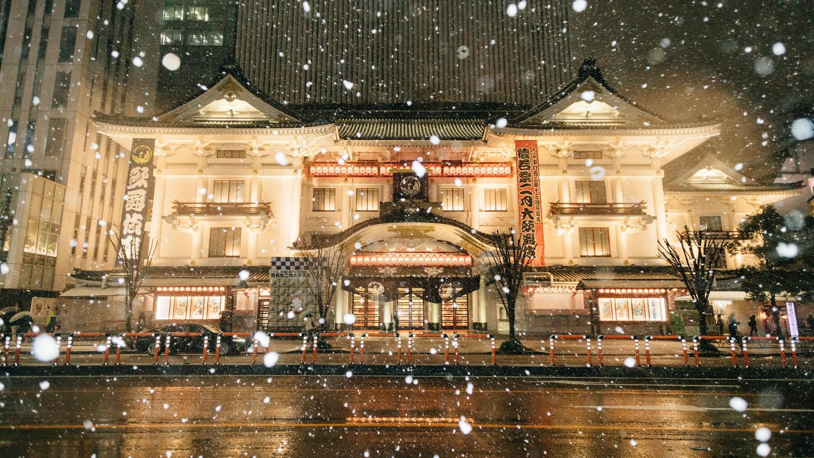 The Kabukiza theatre in Ginza lit up at night as snow falls