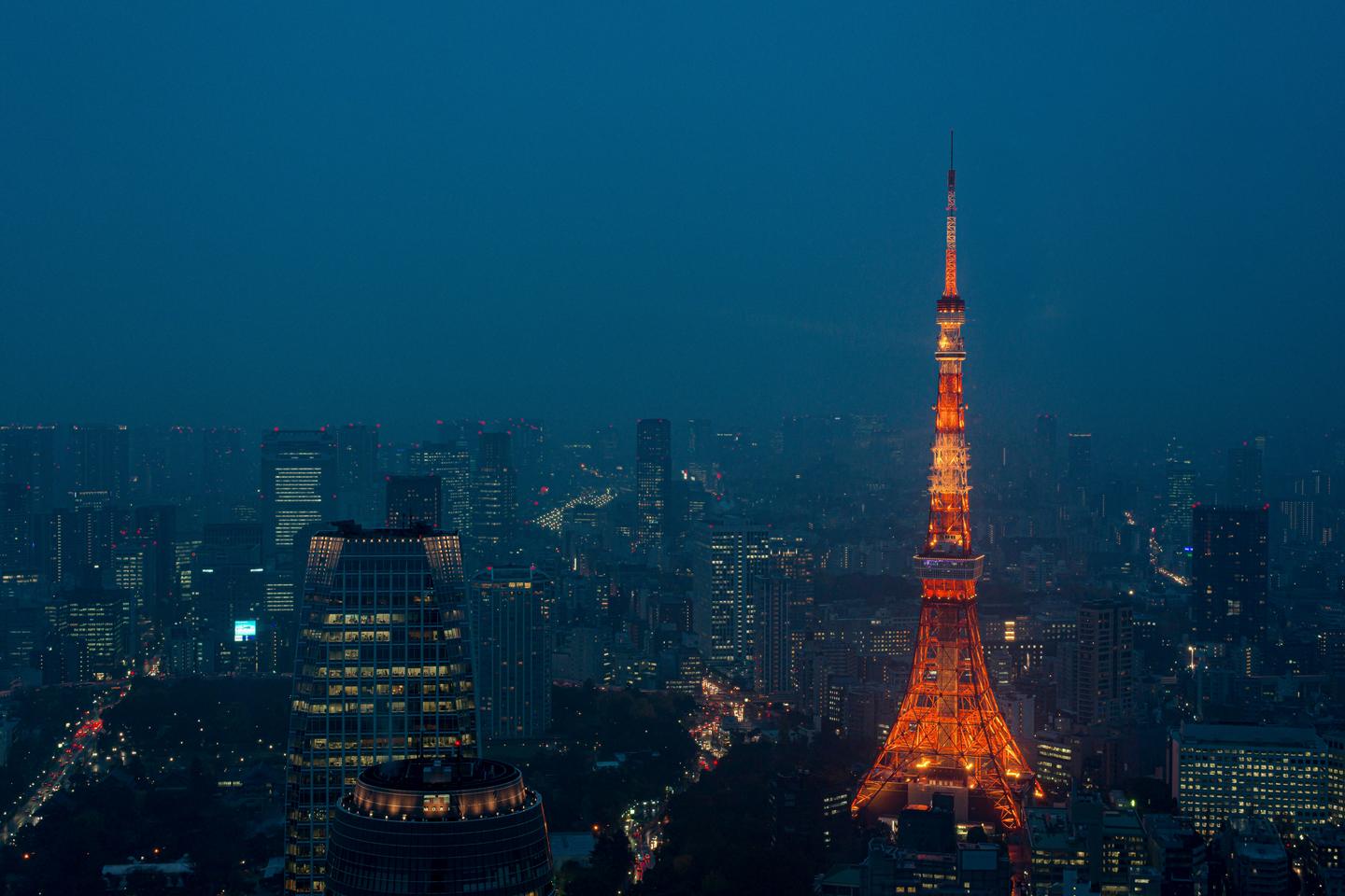 Tokyo Tower lit orange above the city at dusk