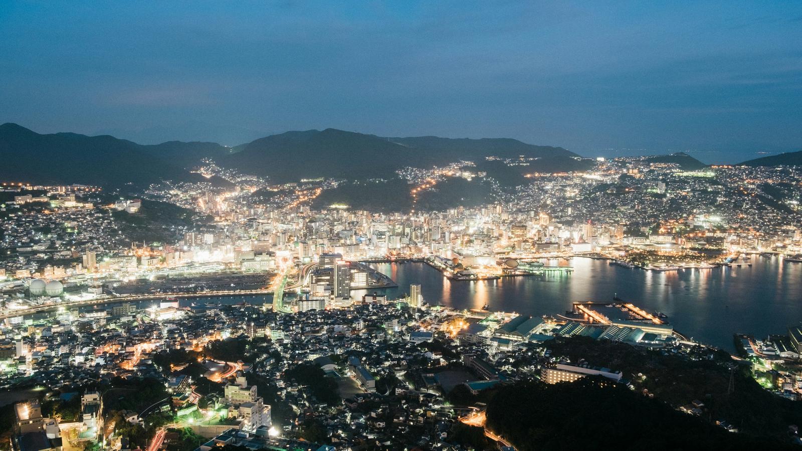 Nagasaki's harbour and city lights seen at dusk from Mount Inasa.