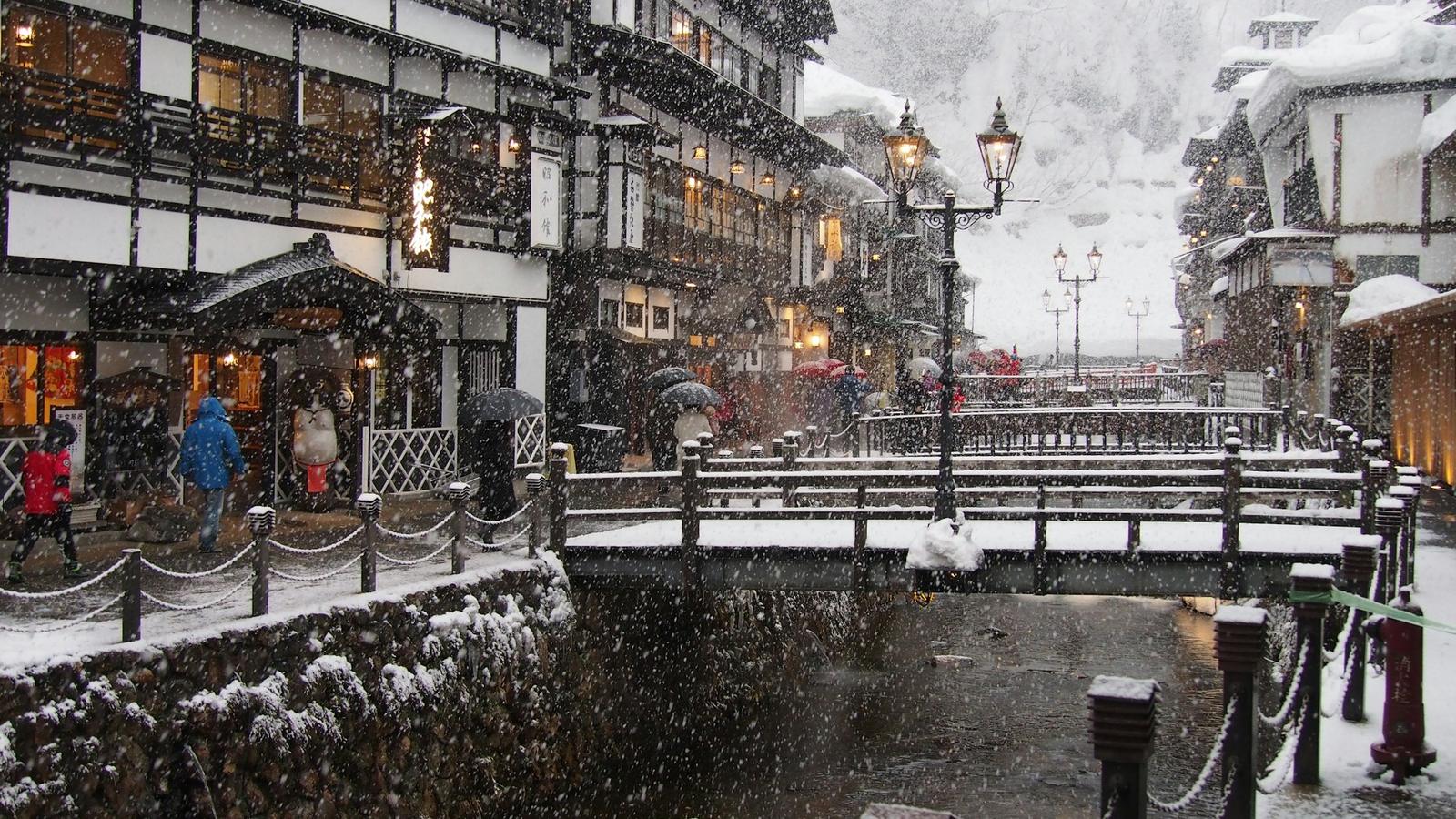飄落在銀山溫泉木造旅館與橋上的雪