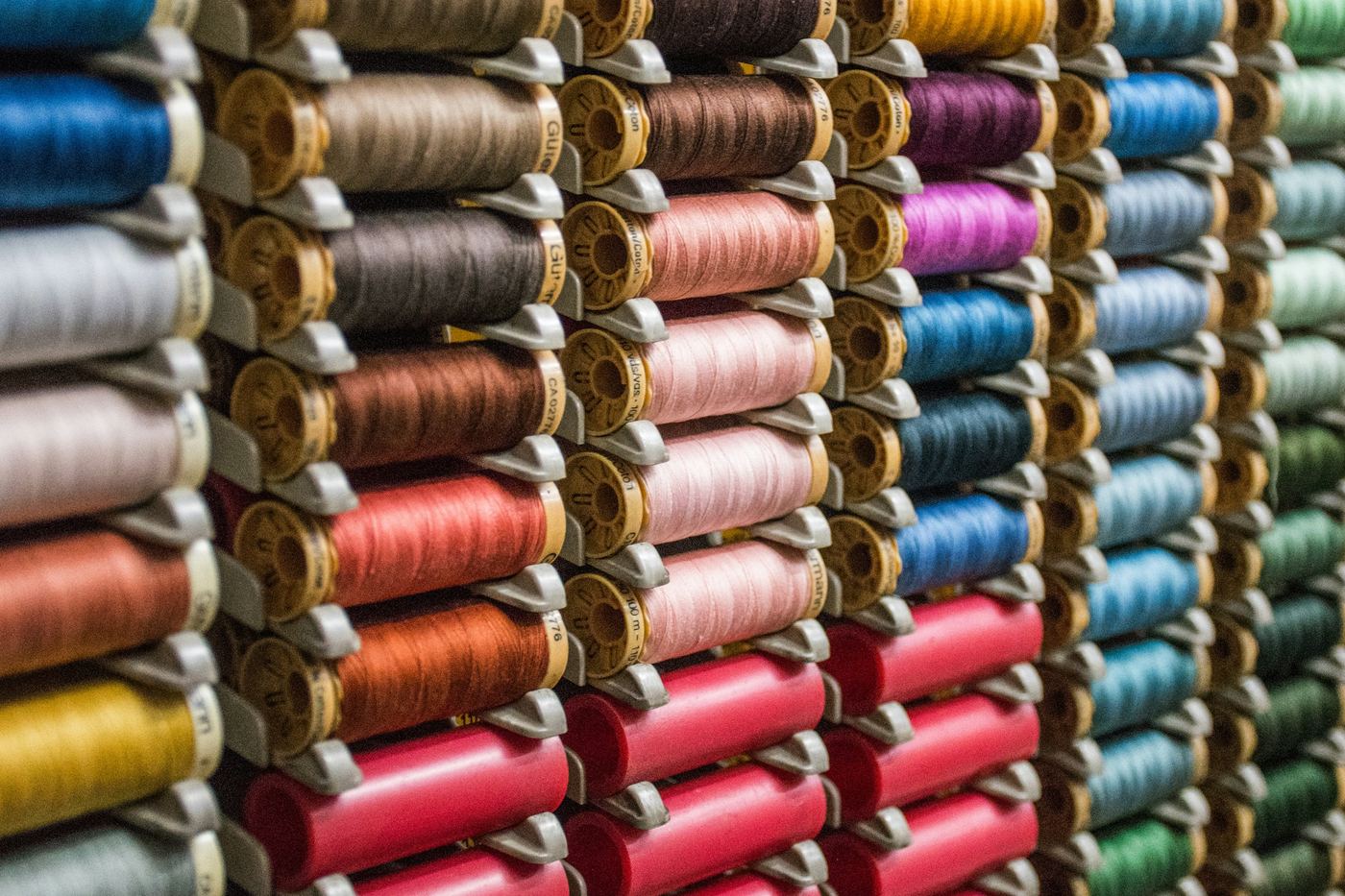 Rows of thread spools in many colours