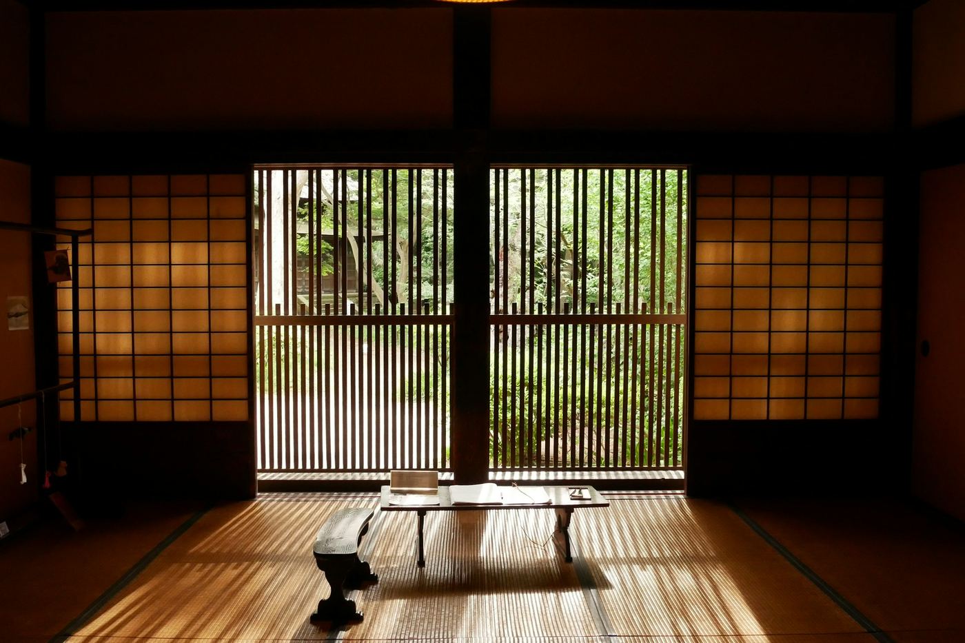 Light through wooden lattice doors onto a tatami floor