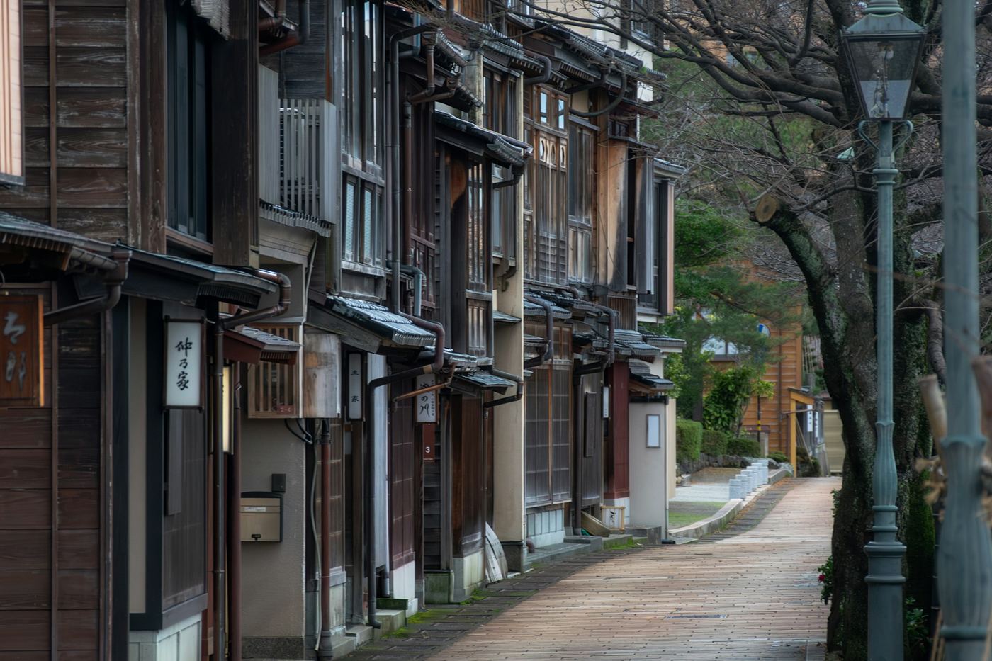 A quiet stone path past old wooden townhouses in Kanazawa